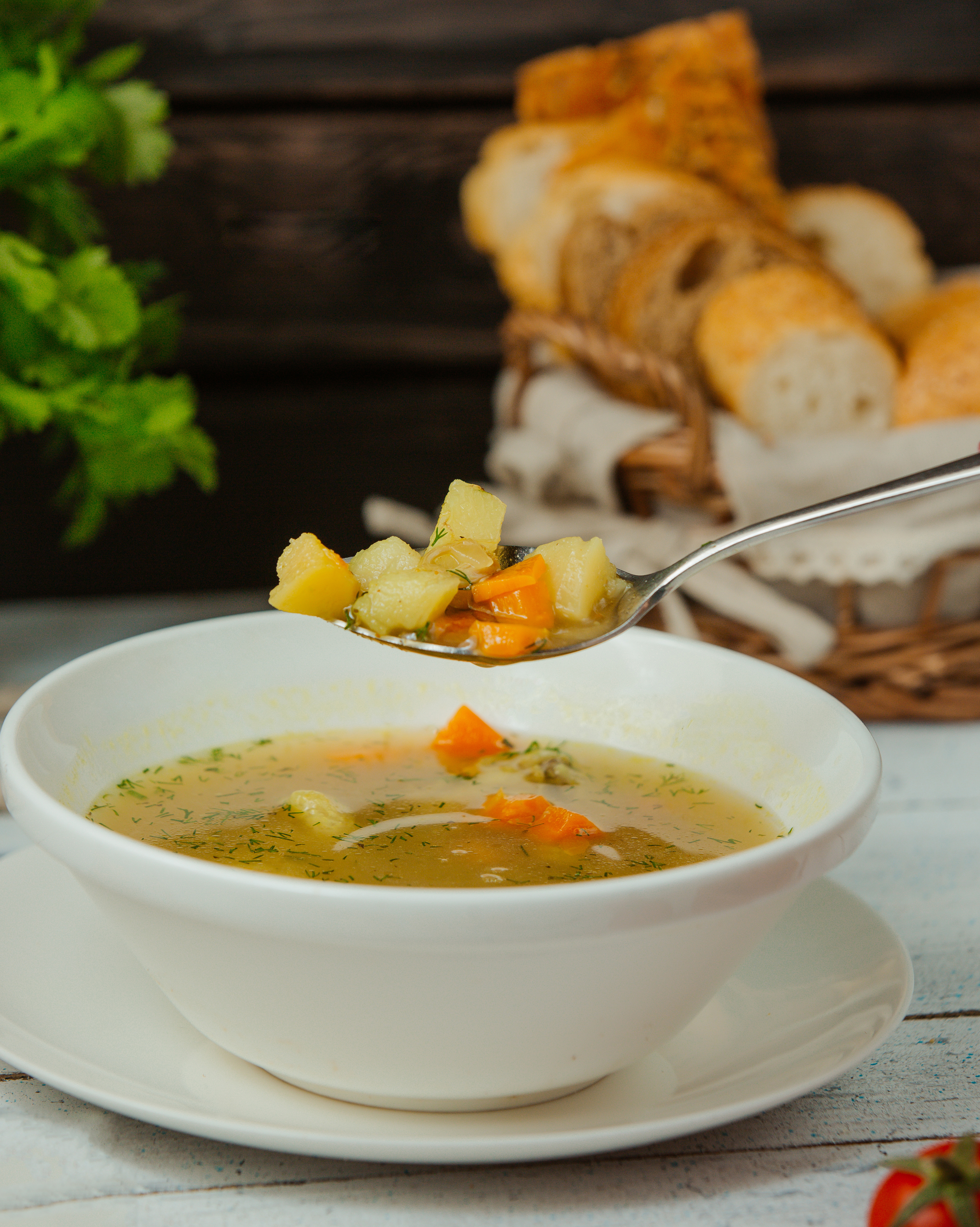 spoon with chicken soup with vegetables dill